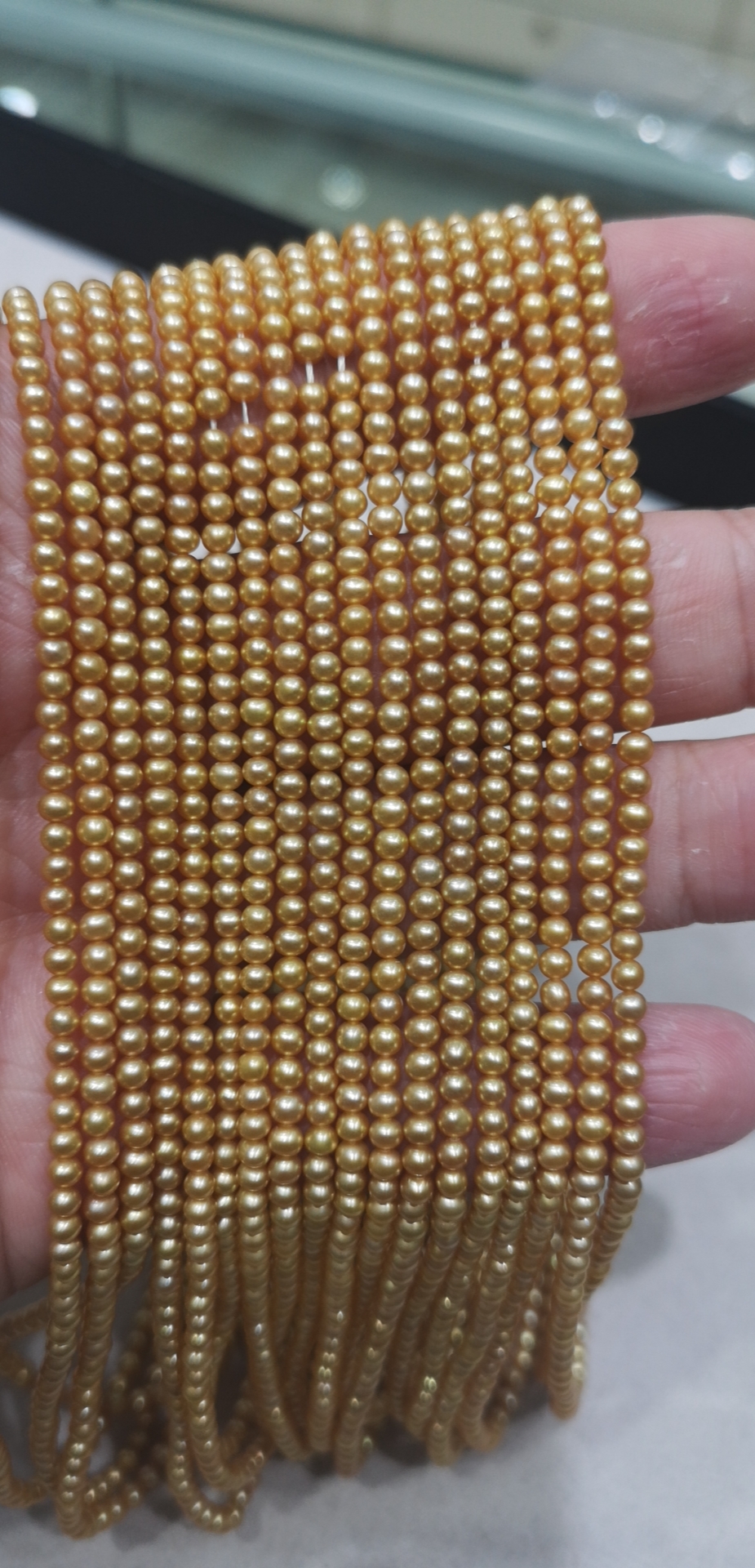 small golden round golden pearls